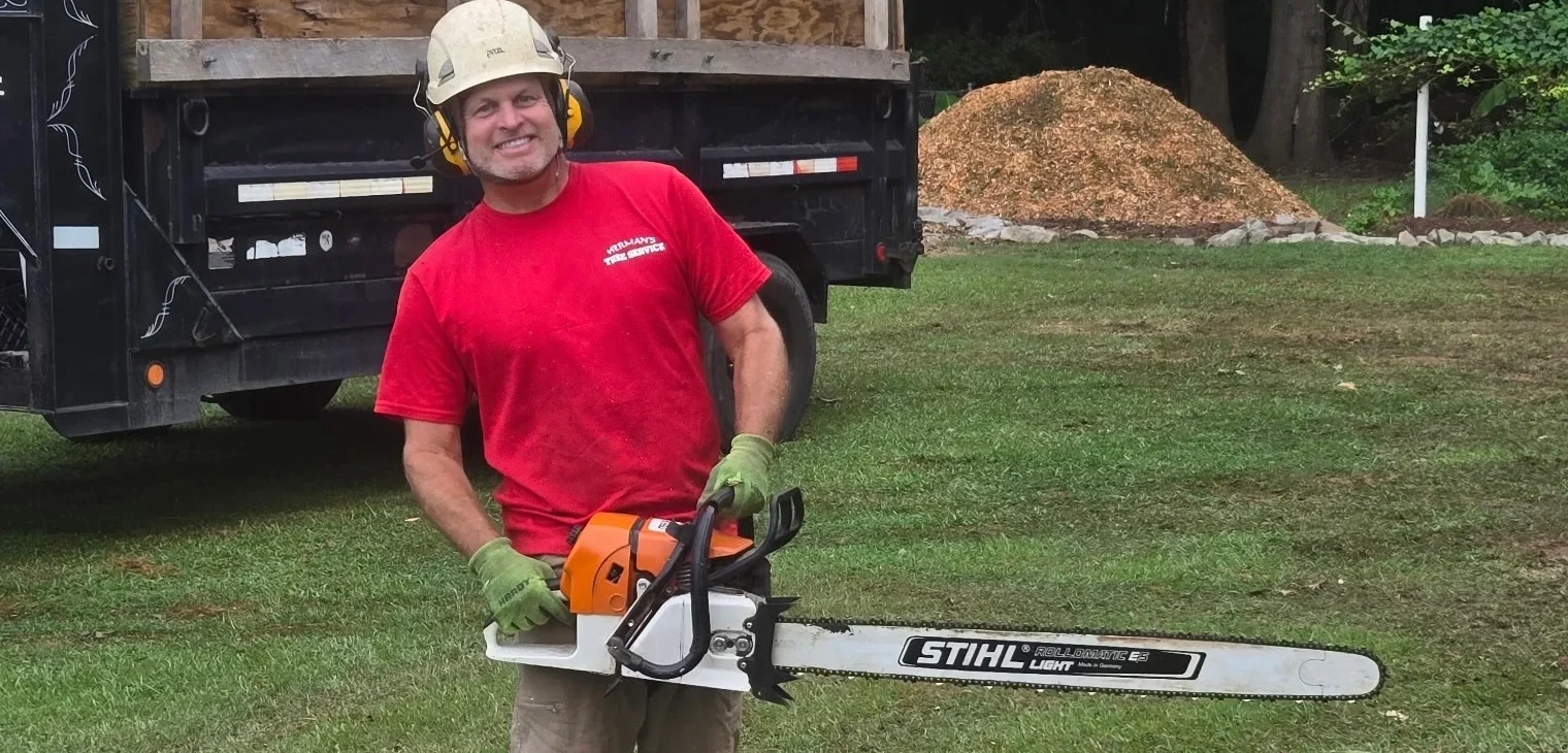 Herman holding Stihl saw - Hermans Tree Service
